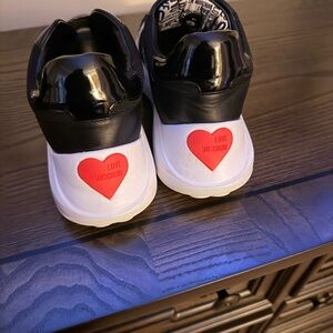 Women’s Designer Moschino Tennis Shoes for sale. The shoes are a size 10.